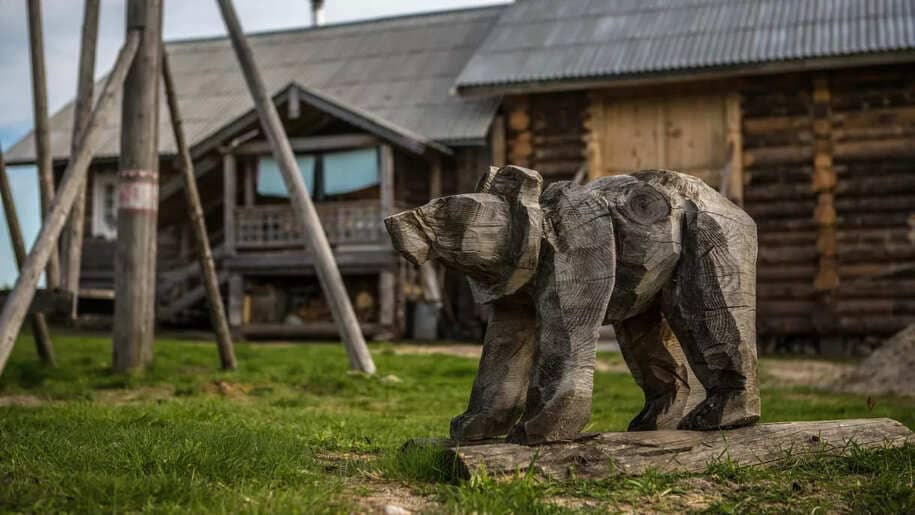 A wooden figure of a bear on a playground in the village of Kinerma in Karelia